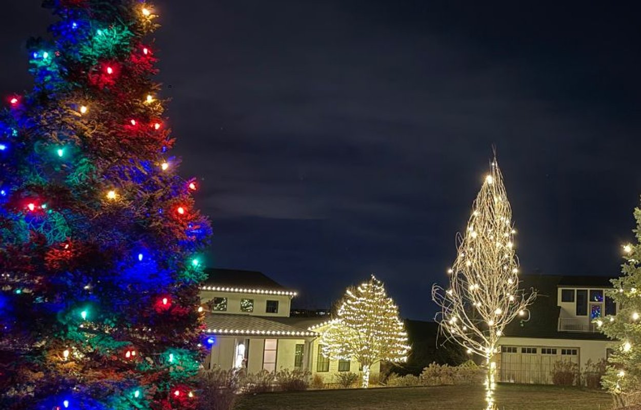 Warm white roofline Christmas lights professionally installed on a Denver metro home