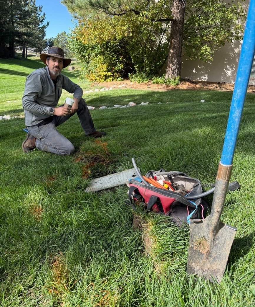 Sunlight Sprinkler technician on site servicing an irrigation valve box in the Denver metro area