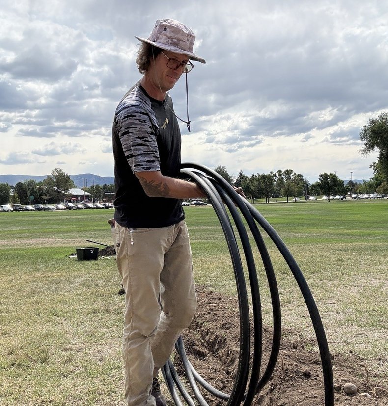 Sunlight Sprinkler owner Shane Plummer laying poly pipe for an irrigation system in the Denver metro area