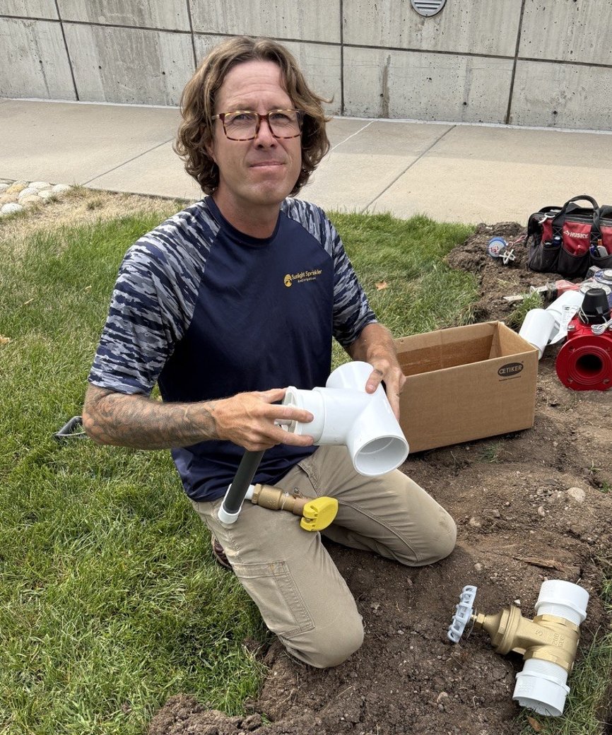 Sunlight Sprinkler founder Shane Plummer installing a backflow preventer assembly in Denver