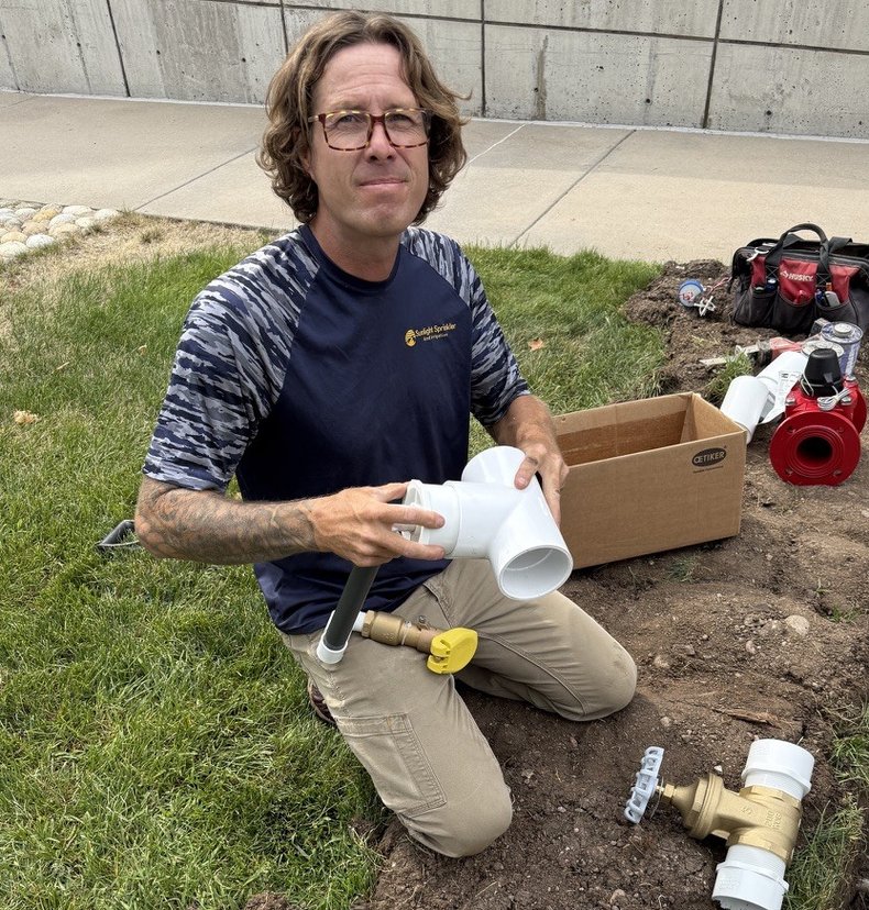 Shane Plummer assembling a backflow preventer for a Denver irrigation system