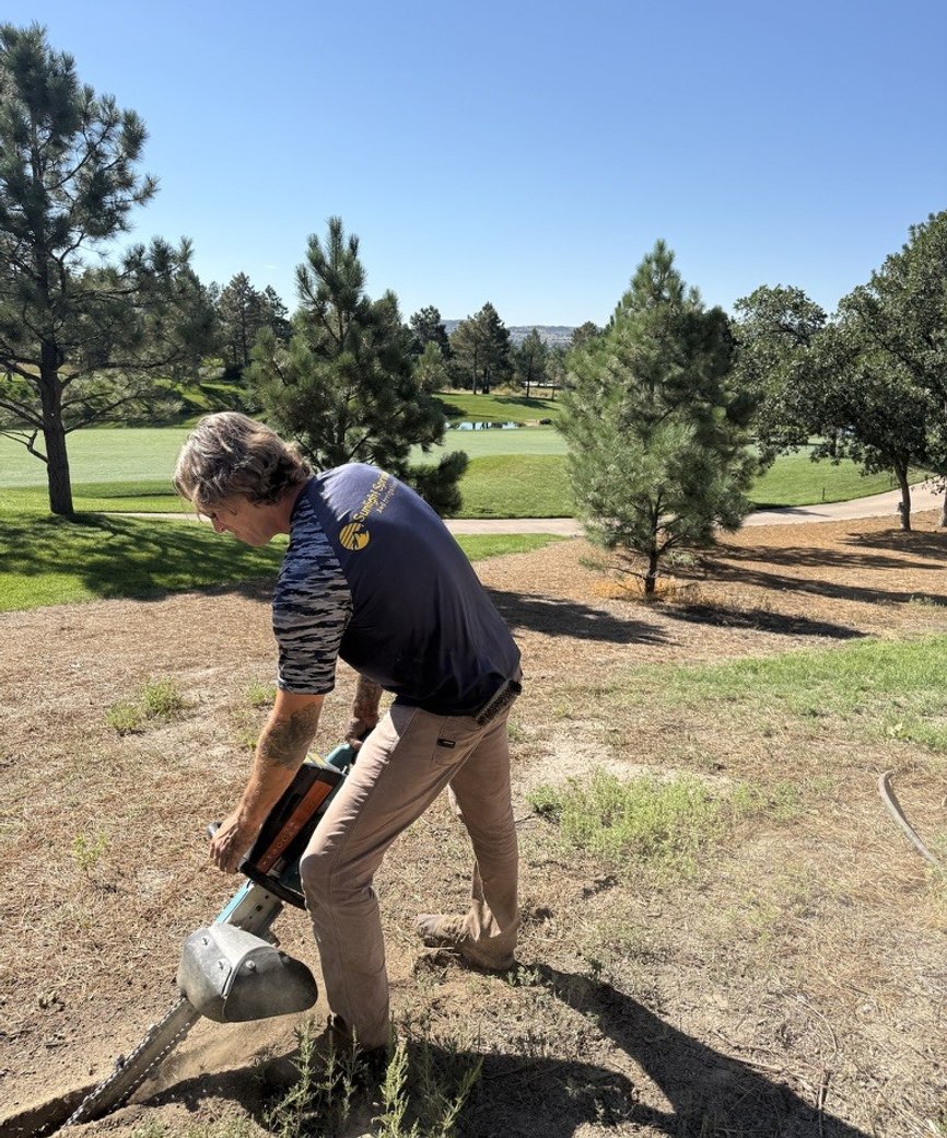 Sunlight Sprinkler installing an irrigation system with a trencher on a Colorado golf course